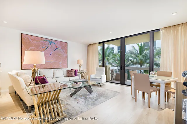 a living room with furniture and floor to ceiling windows