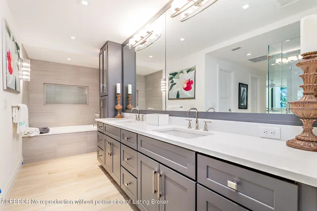 a spacious bathroom with a sink double vanity and a bathtub