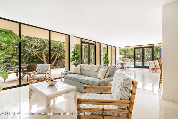 a living room with furniture and large windows