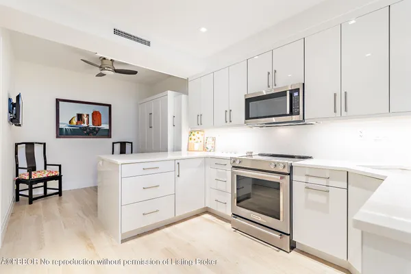 a kitchen with stainless steel appliances granite countertop a stove microwave and cabinets