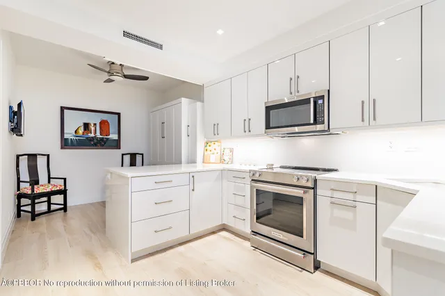 a kitchen with stainless steel appliances granite countertop a stove microwave and cabinets