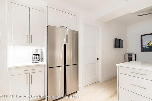 a kitchen with stainless steel appliances a refrigerator sink and cabinets