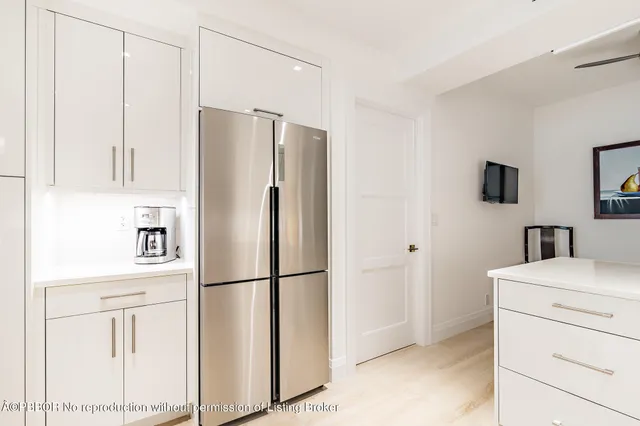 a kitchen with stainless steel appliances a refrigerator sink and cabinets
