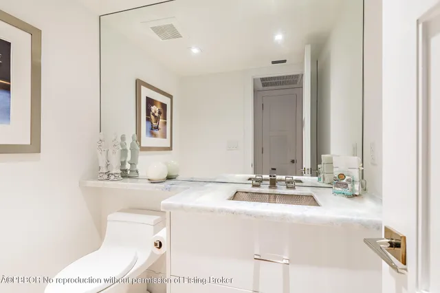 a bathroom with a sink a toilet and mirror