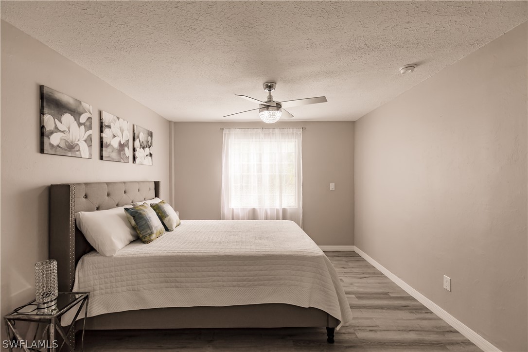 8049 Albatross Road Fort Myers, FL 33967 - Photo 11 of 35 a bedroom with a large bed and a window