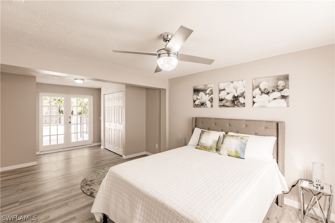 8049 Albatross Road Fort Myers, FL 33967 - Photo 12 of 35 a bedroom with a large bed and a chandelier