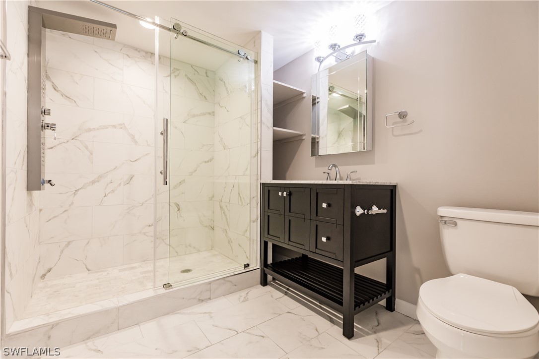 8049 Albatross Road Fort Myers, FL 33967 - Photo 15 of 35 a bathroom with a toilet sink and shower