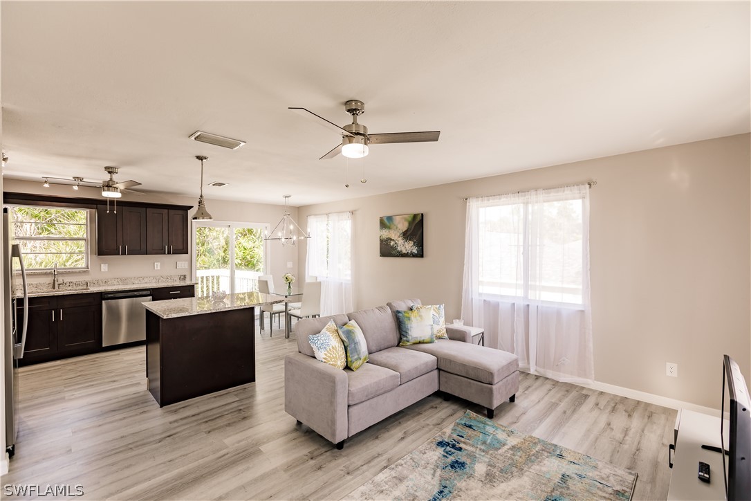 8049 Albatross Road Fort Myers, FL 33967 - Photo 18 of 35 a living room with furniture window and wooden floor