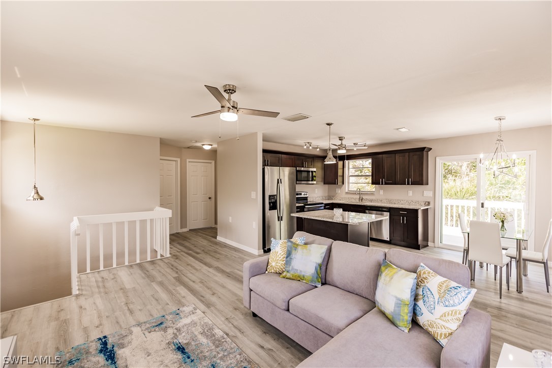 8049 Albatross Road Fort Myers, FL 33967 - Photo 19 of 35 a living room with furniture and kitchen view