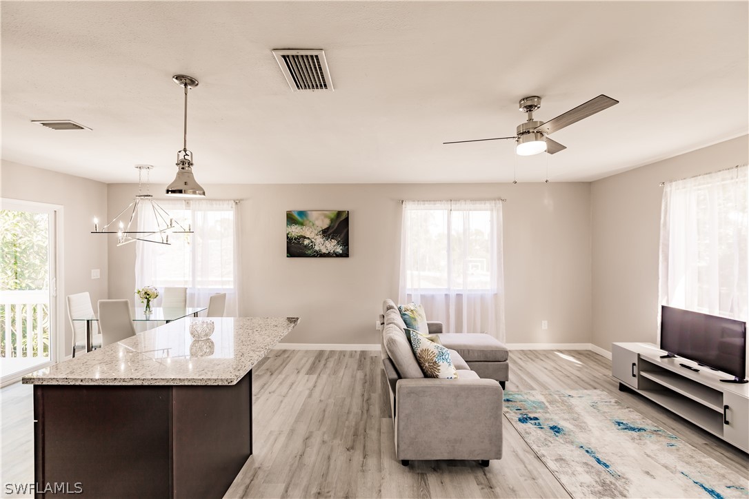 8049 Albatross Road Fort Myers, FL 33967 - Photo 20 of 35 a living room with furniture and a chandelier