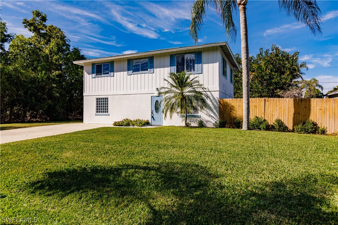 8049 Albatross Road Fort Myers, FL 33967 - Photo 2 of 35 a front view of a house with garden