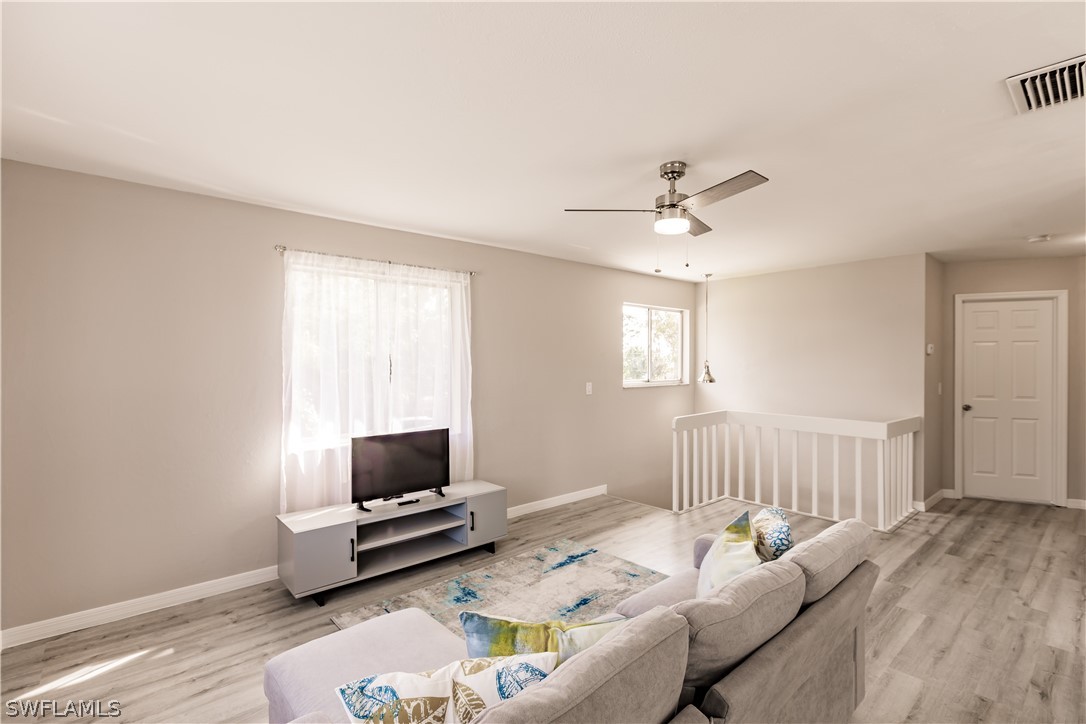 8049 Albatross Road Fort Myers, FL 33967 - Photo 21 of 35 a living room with furniture and a window