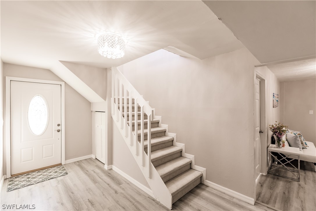 8049 Albatross Road Fort Myers, FL 33967 - Photo 5 of 35 a view of entryway and hall with wooden floor