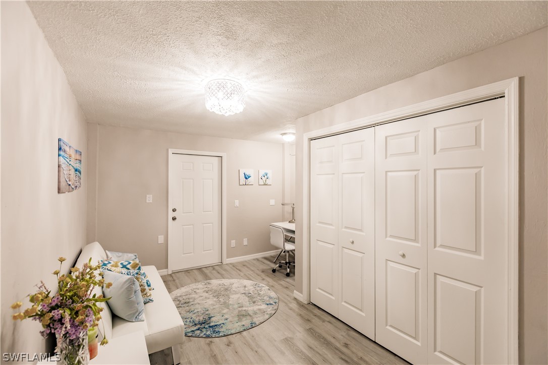 8049 Albatross Road Fort Myers, FL 33967 - Photo 6 of 35 a bedroom with a bed and a hallway