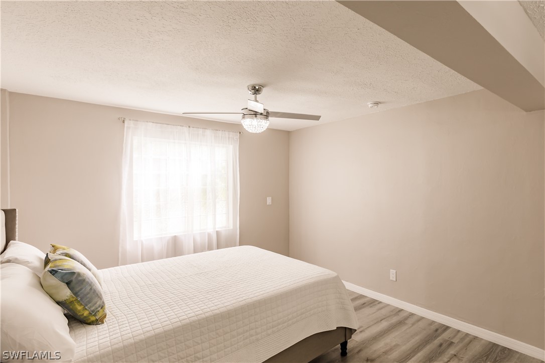 8049 Albatross Road Fort Myers, FL 33967 - Photo 10 of 35 a bedroom with a bed and a window