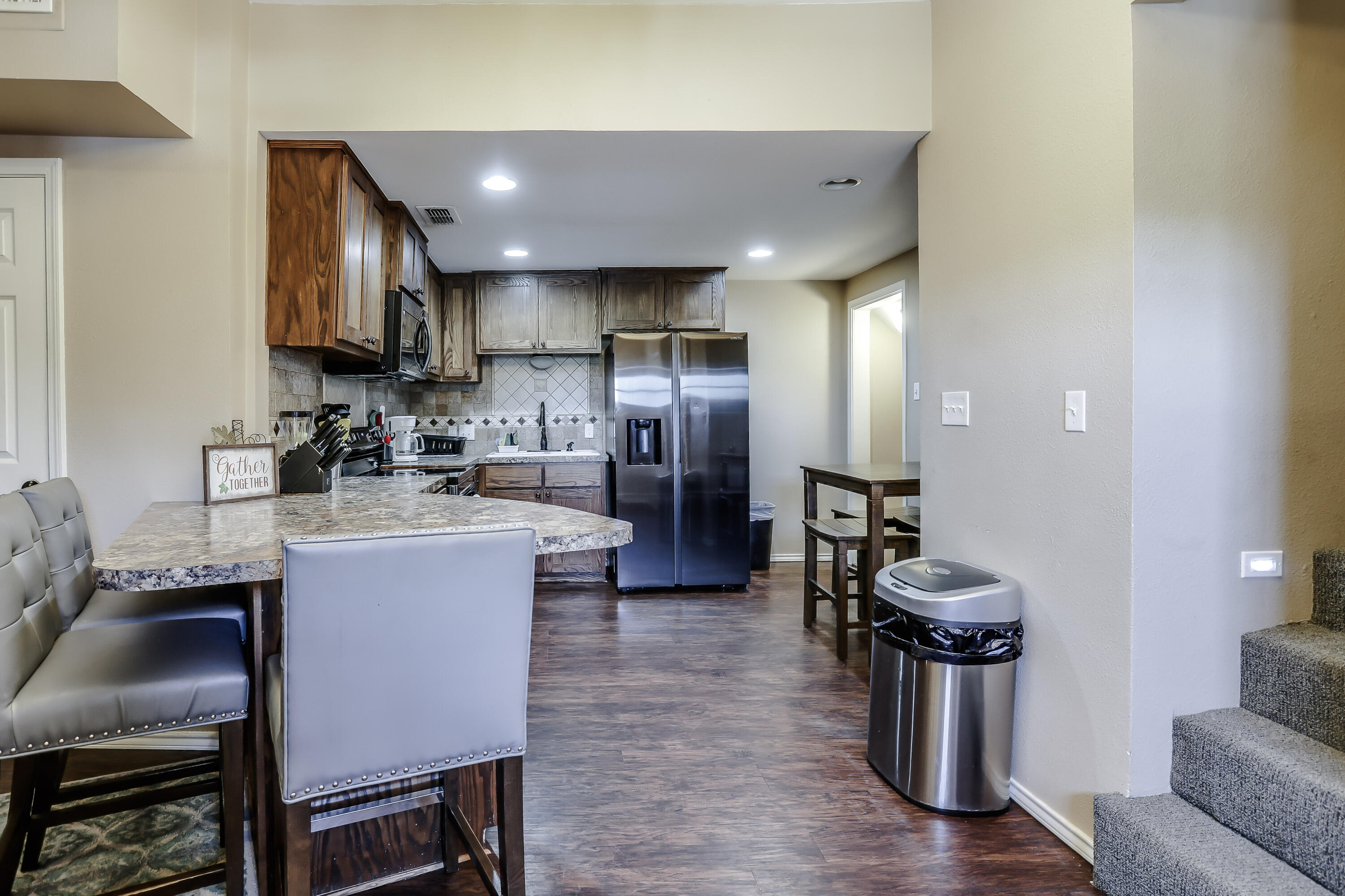68 Pony Express Trail Lubbock, TX 79404 - Photo 7 of 15 a kitchen with a refrigerator and a sink