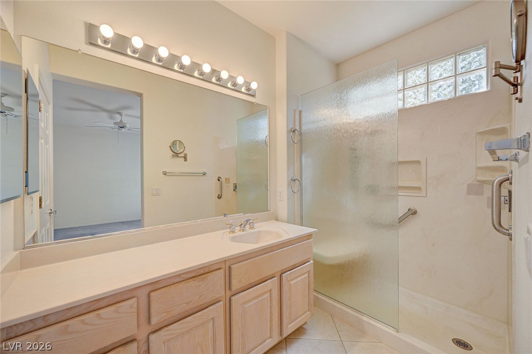 2529 Springville Way Henderson, NV 89052 - Photo 35 of 70 Tiled flooring and a walk-in shower with a glass enclosure accent the bathroom.