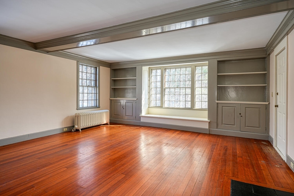 209 Main Street, Unit B Medway, MA 02053 - Photo 2 of 12 a view of an empty room with a window and wooden floor
