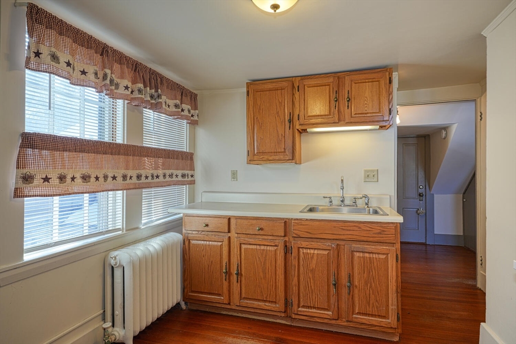 209 Main Street, Unit B Medway, MA 02053 - Photo 5 of 12 a bathroom with a sink a mirror and a window