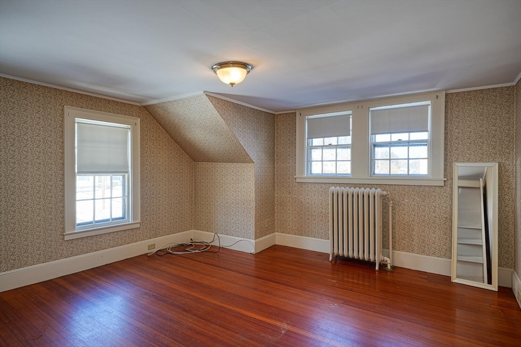 209 Main Street, Unit B Medway, MA 02053 - Photo 6 of 12 an empty room with wooden floor and windows