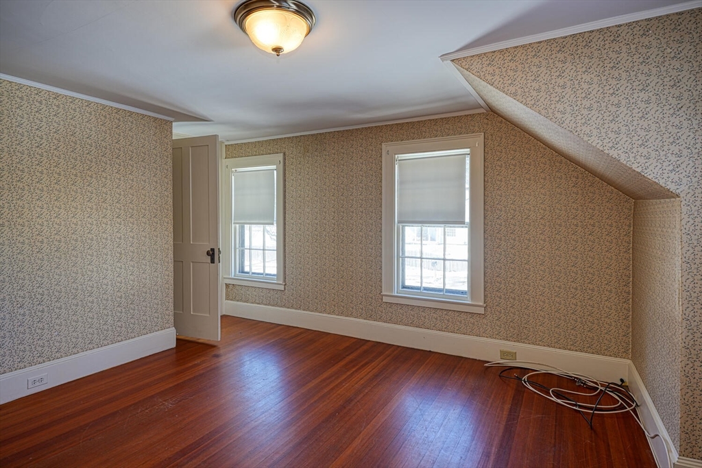 209 Main Street, Unit B Medway, MA 02053 - Photo 7 of 12 an empty room with wooden floor and windows