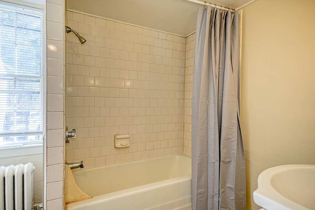 209 Main Street, Unit B Medway, MA 02053 - Photo 9 of 12 a bathroom with a bathtub and a shower