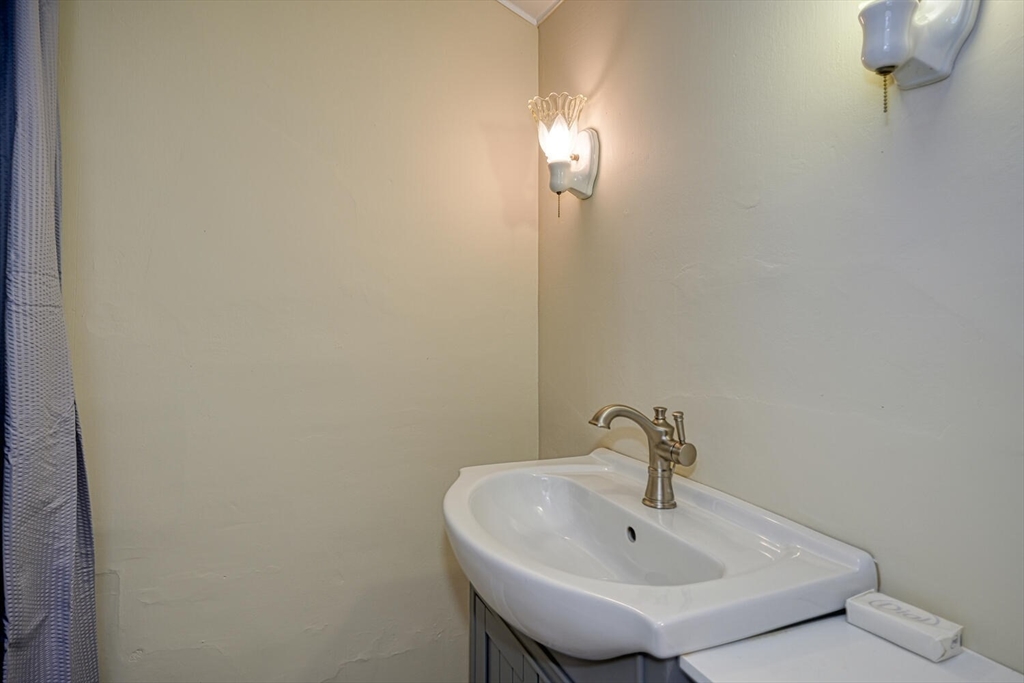 209 Main Street, Unit B Medway, MA 02053 - Photo 10 of 12 a bathroom with a sink and a mirror