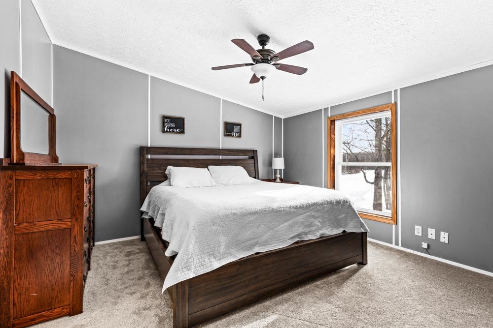 4231 Stockholm Road Duluth, MN 55803 - Photo 20 of 50 Carpeted bedroom featuring lofted ceiling, ceiling fan, and a textured ceiling