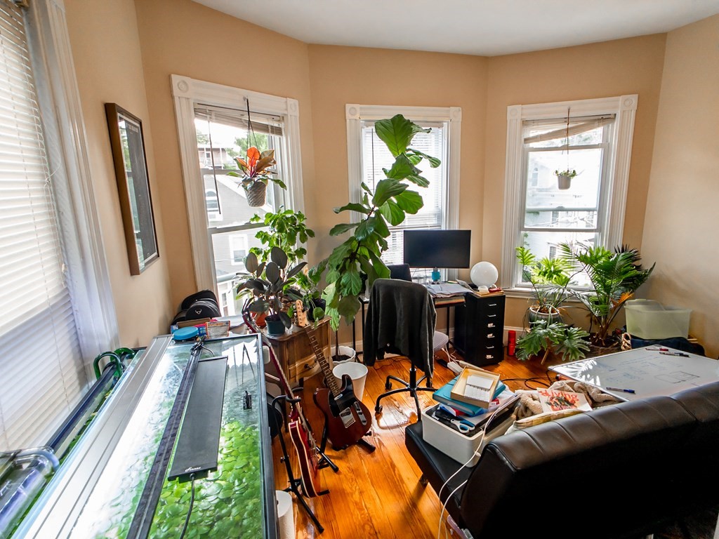 30 Spring Park Avenue, Unit 3 Boston, MA 02130 - Photo 4 of 12 a view of a balcony with chair and wooden floor