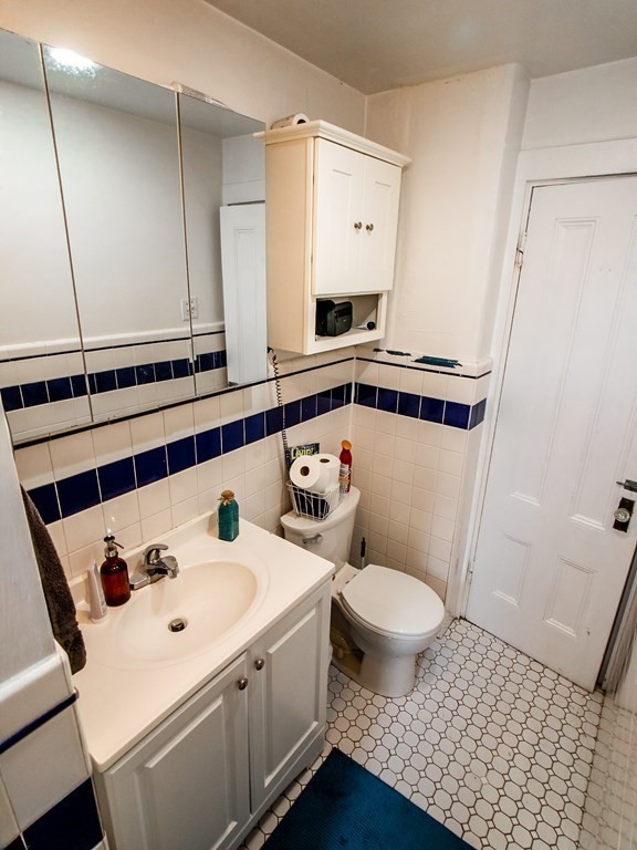 30 Spring Park Avenue, Unit 3 Boston, MA 02130 - Photo 7 of 12 a bathroom with a sink a toilet and a mirror