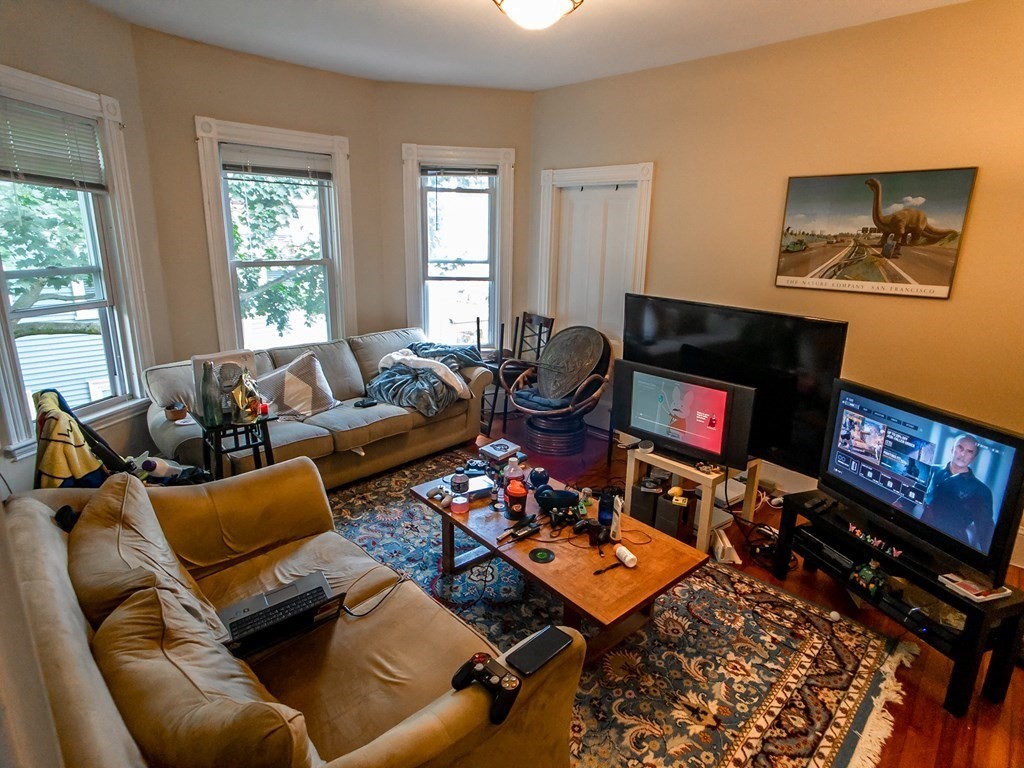 30 Spring Park Avenue, Unit 3 Boston, MA 02130 - Photo 8 of 12 a living room with furniture a flat screen tv and a window