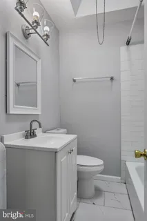 a bathroom with a sink a toilet and mirror