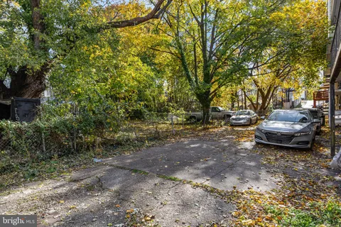 a view of a backyard with table and chairs