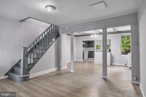 a view of a hallway with wooden floor and entryway