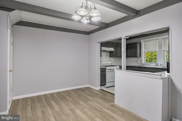 a view of a kitchen with a dishwasher cabinets and a wooden floor