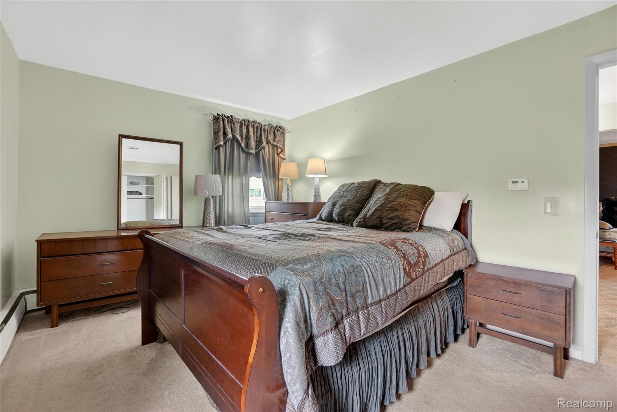 7358 Morrish Road Swartz Creek, MI 48473 - Photo 17 of 39 Bedroom featuring light colored carpet and a baseboard radiator