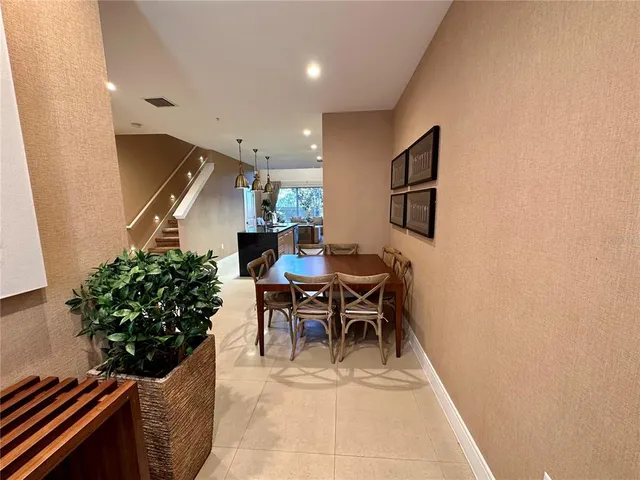 a living room with furniture potted plant and a window