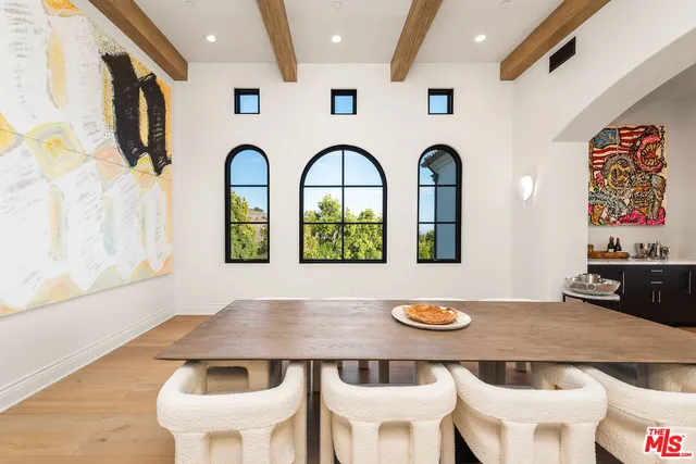 a kitchen with a table chairs and a wooden floor