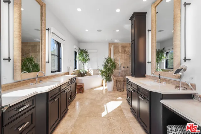 a large kitchen with kitchen island a sink stainless steel appliances and cabinets
