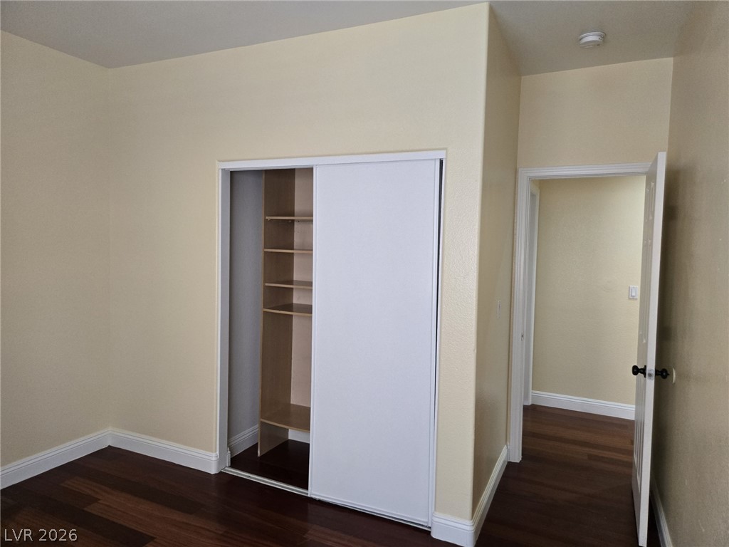 8417 San Ramon Drive Las Vegas, NV 89147 - Photo 23 of 33 Rich hardwood flooring complements a built-in closet, offering efficient storage within this functional space.