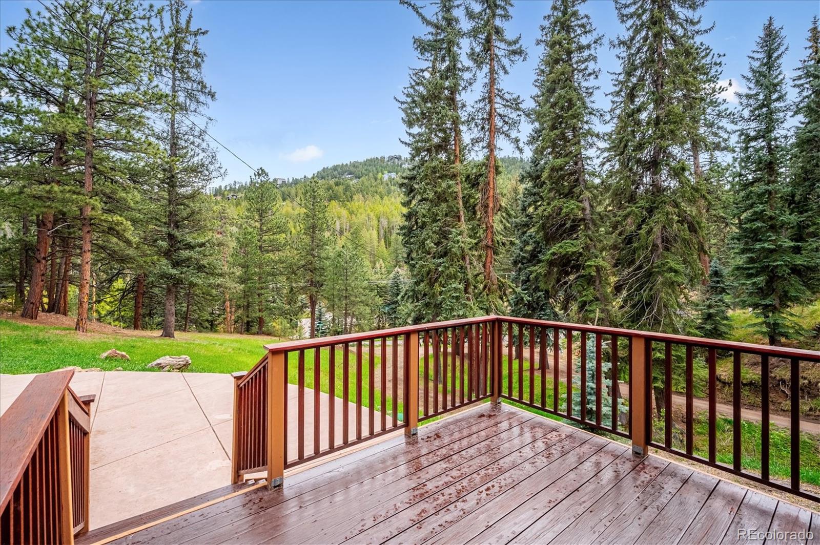 6747 South Brook Forest Road Evergreen, CO 80439 - Photo 41 of 49 a view of balcony with wooden floor and yard