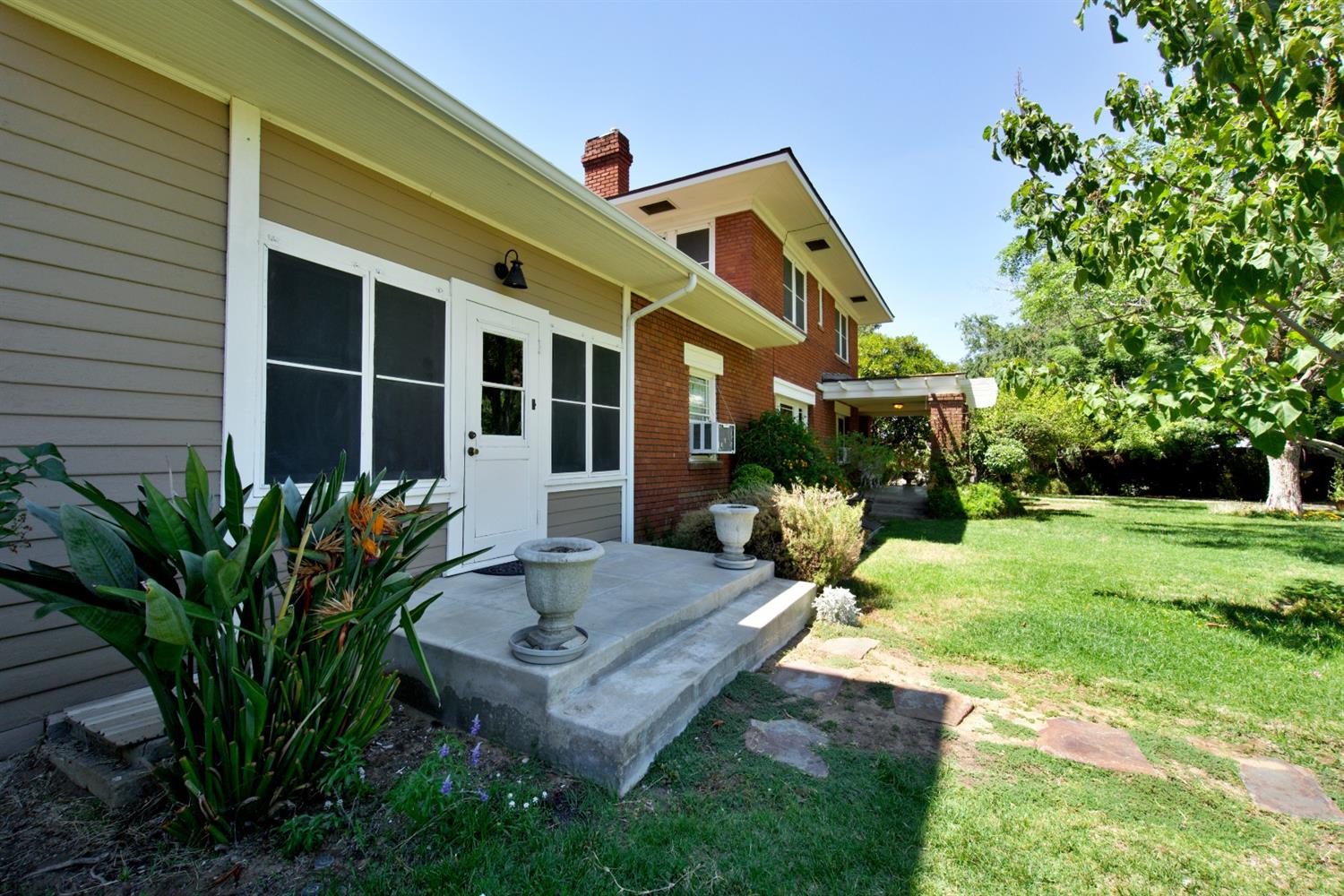 2220 Dewitt Avenue Clovis, CA 93612 - Photo 3 of 44 a front view of a house with garden and sitting area