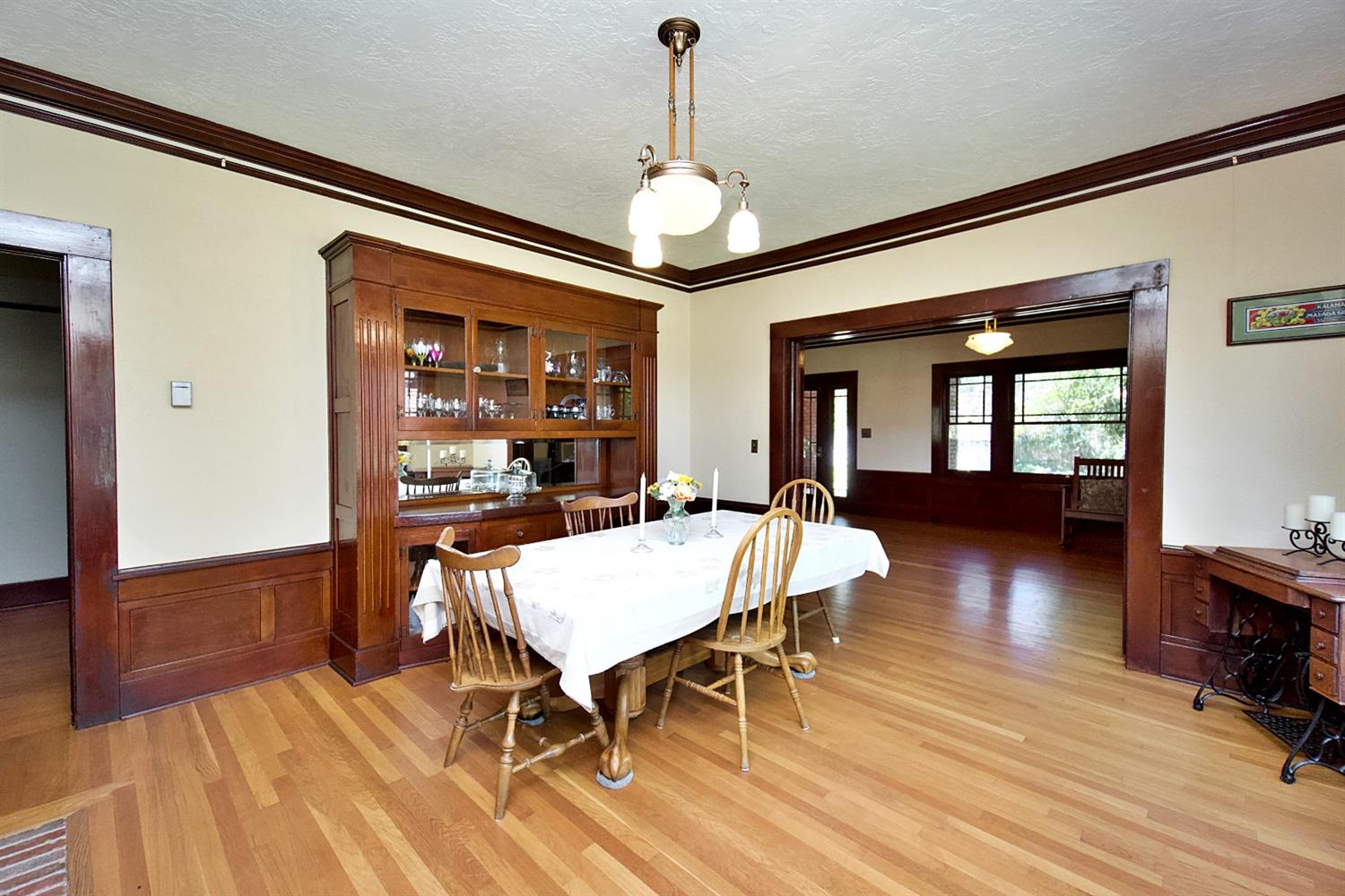 2220 Dewitt Avenue Clovis, CA 93612 - Photo 10 of 44 a dining room with wooden floor a chandelier a wooden table and chairs
