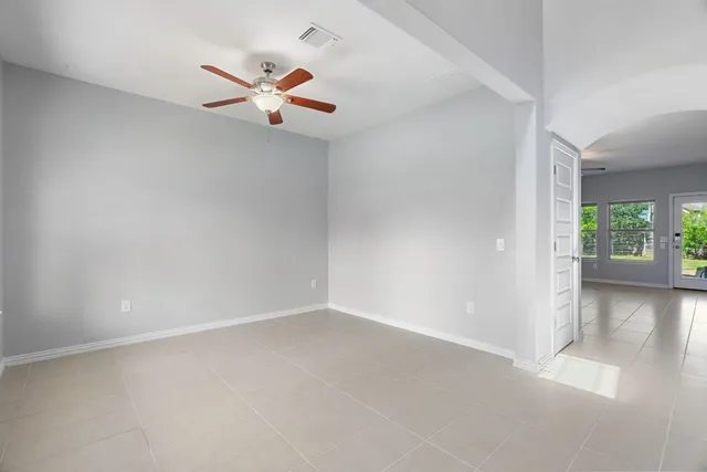 a bathroom with a granite countertop sink a toilet a mirror and shower