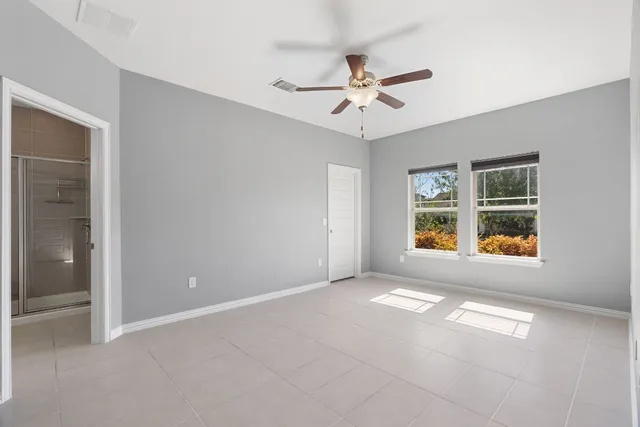 a view of small space with racks on the wall and a window