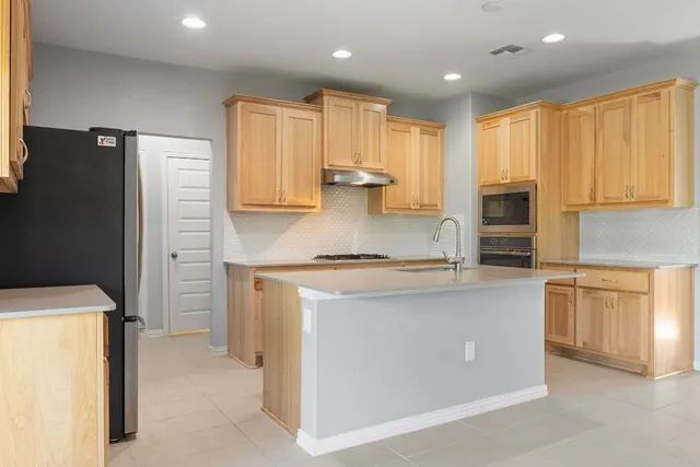 a view of an empty room with closet and a chandelier fan