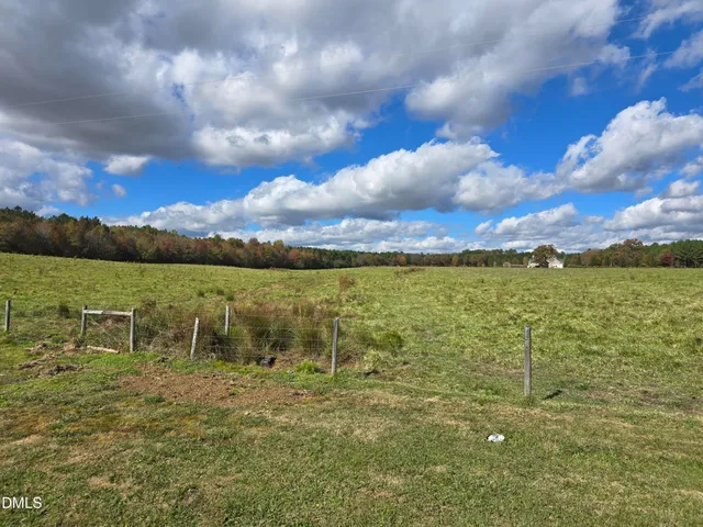 a view of a field with an ocean