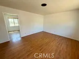 an empty room with wooden floor