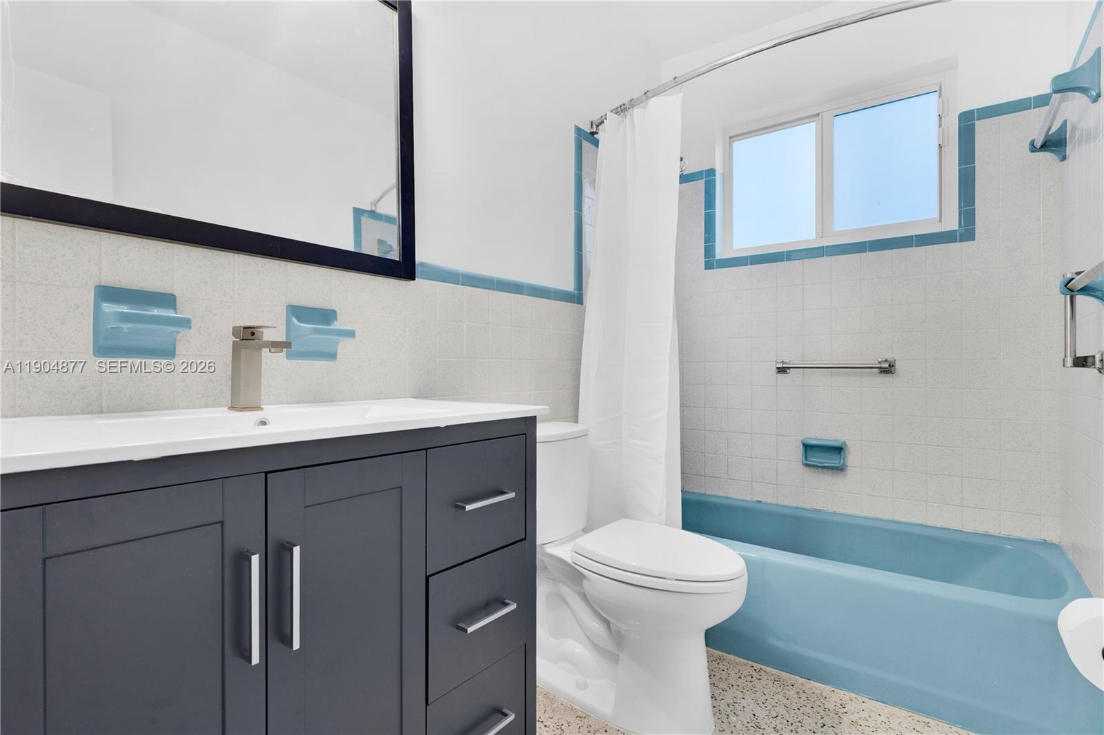 2931 Southwest 39th Avenue Miami, FL 33134 - Photo 16 of 27 a bathroom with a sink a toilet a mirror and shower