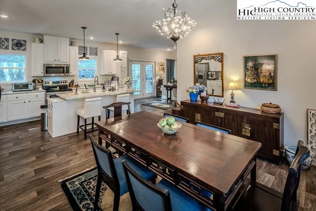a kitchen with a dining table chairs and kitchen view